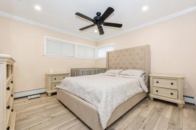 a bedroom with a bed and a ceiling fan