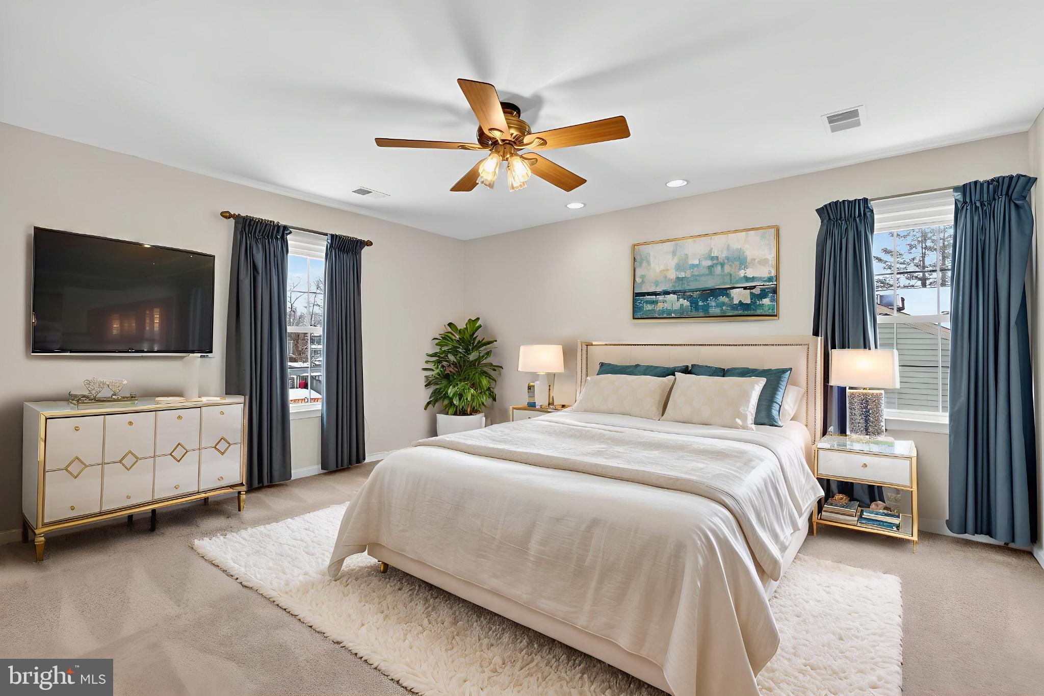 8836 Shadowlake Way Springfield, VA 22153 - Photo 13 of 77 a spacious bedroom with a large bed and a flat screen tv