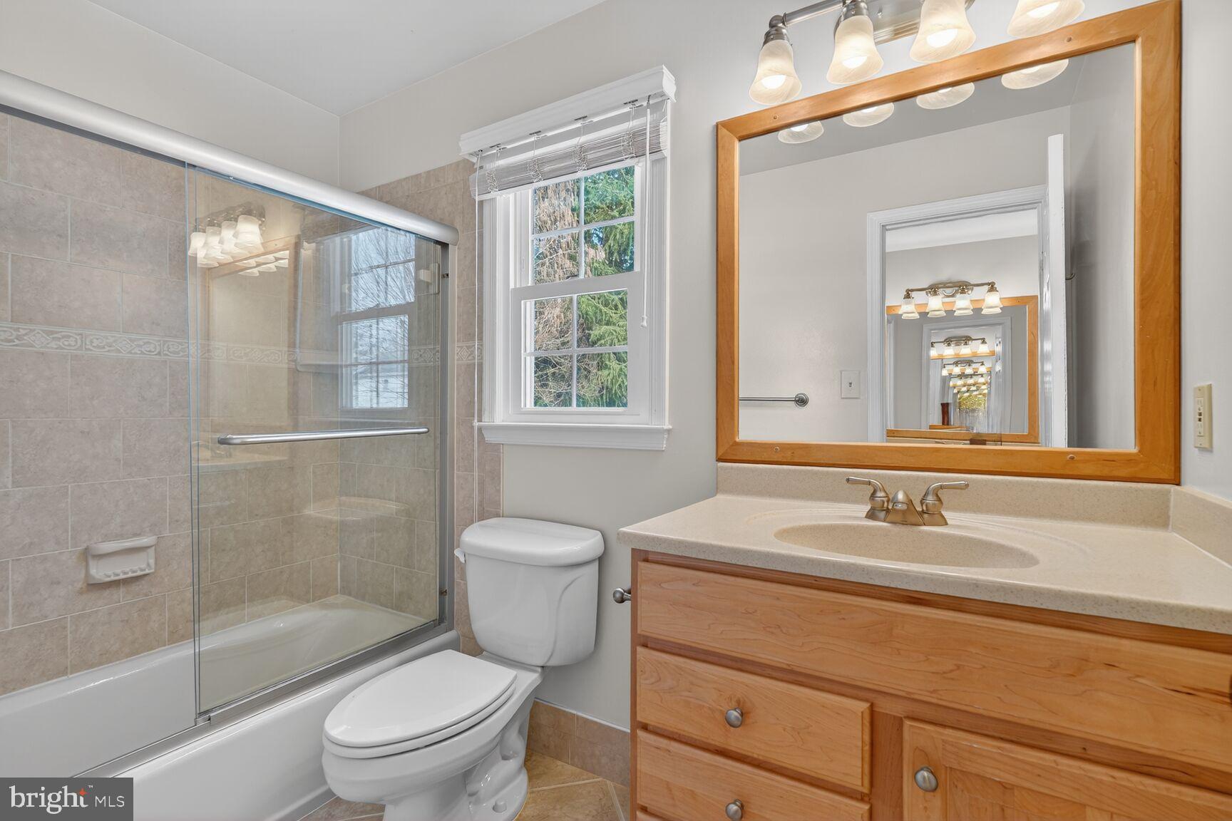 8836 Shadowlake Way Springfield, VA 22153 - Photo 14 of 77 a bathroom with a sink a toilet and shower