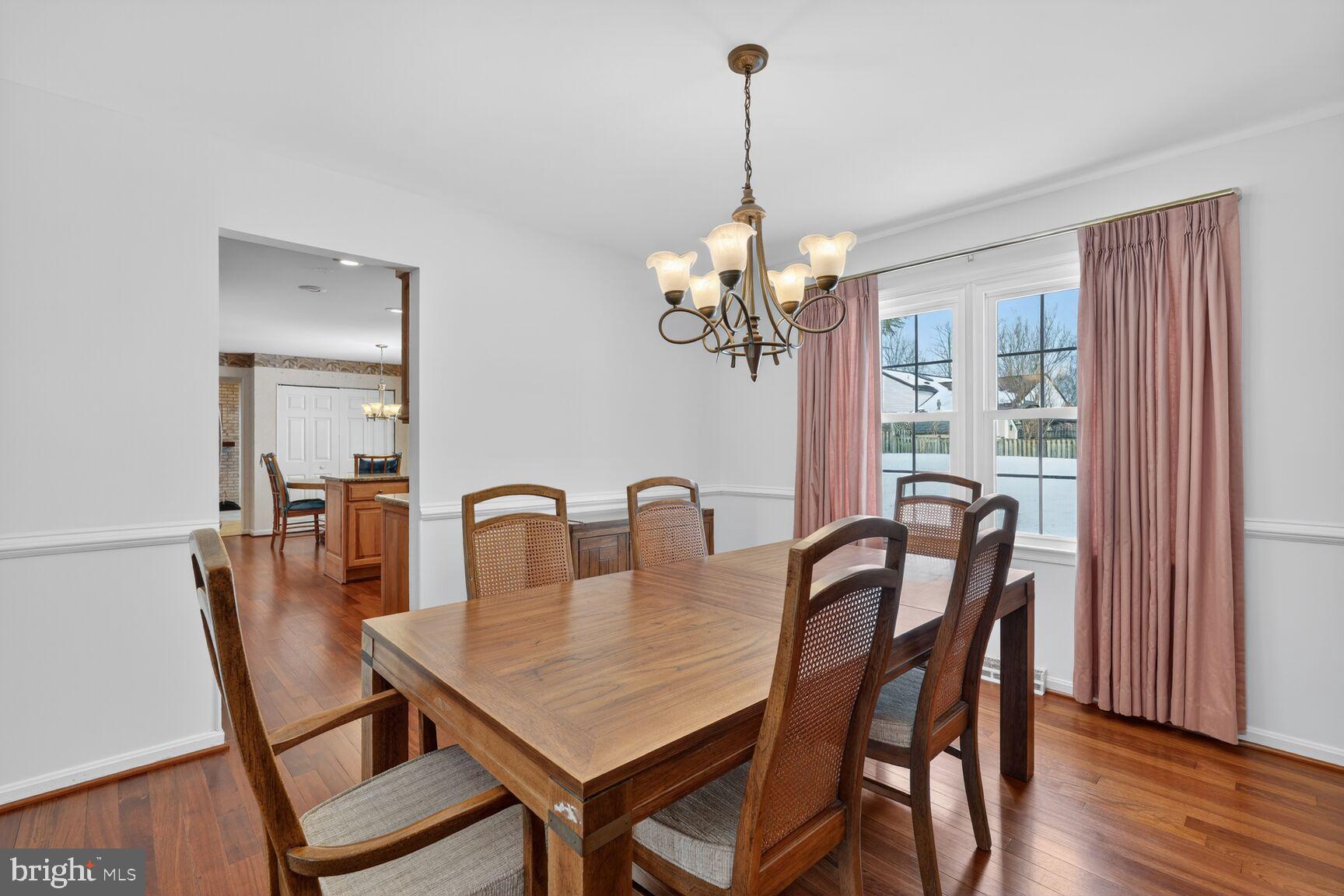 8836 Shadowlake Way Springfield, VA 22153 - Photo 30 of 77 a view of a dining room with furniture wooden floor and chandelier
