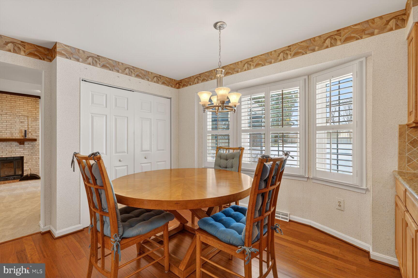 8836 Shadowlake Way Springfield, VA 22153 - Photo 32 of 77 a dining room with furniture window and wooden floor