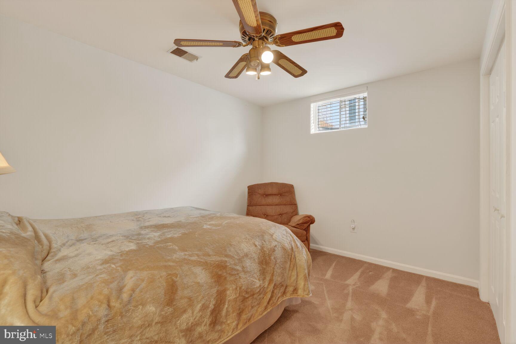 8836 Shadowlake Way Springfield, VA 22153 - Photo 48 of 77 a bedroom with a bed and a ceiling fan