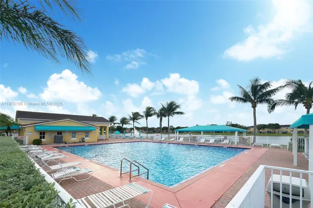 a view of swimming pool with outdoor seating and lake view
