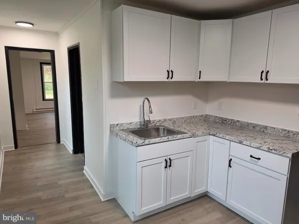 a kitchen with white cabinets
