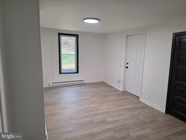 an empty room with windows and closet