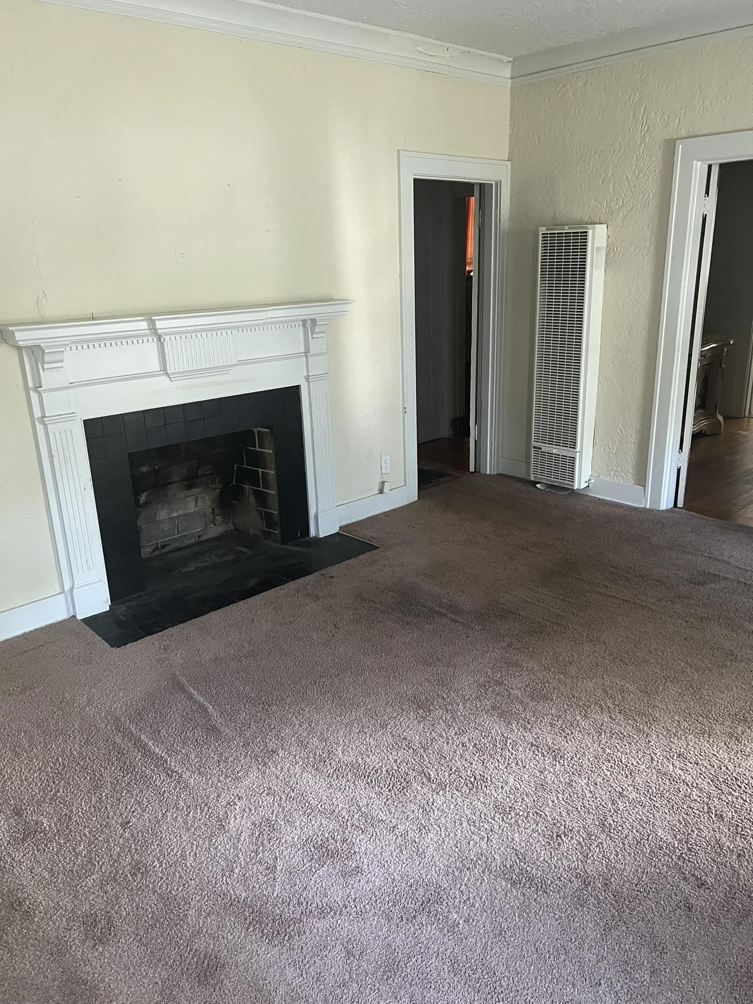 632 Spring Street Memphis, TN 38112 - Photo 28 of 37 Unfurnished living room with crown molding and dark colored carpet