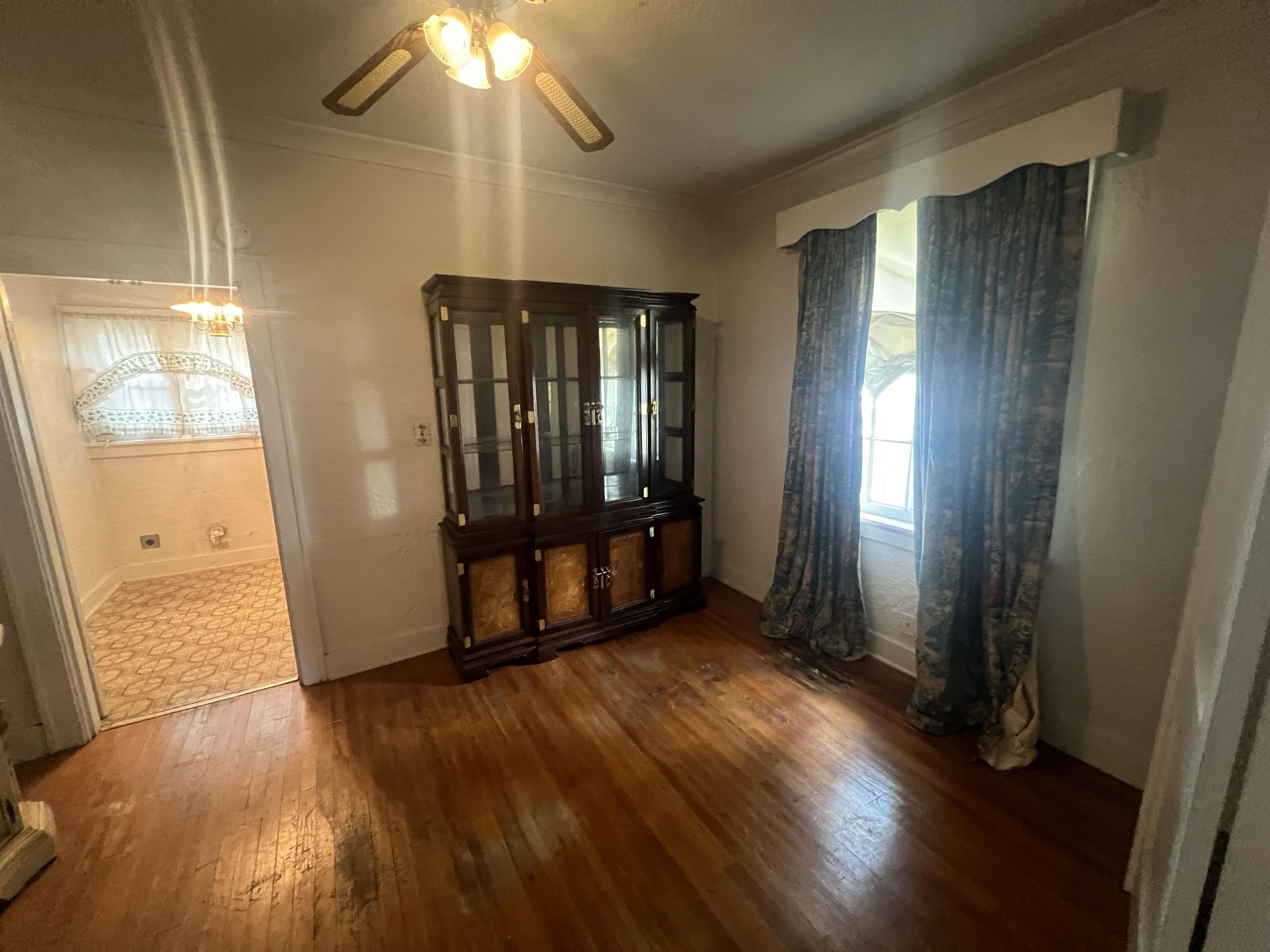 632 Spring Street Memphis, TN 38112 - Photo 6 of 37 Spare room with ceiling fan, dark hardwood / wood-style floors, and crown molding