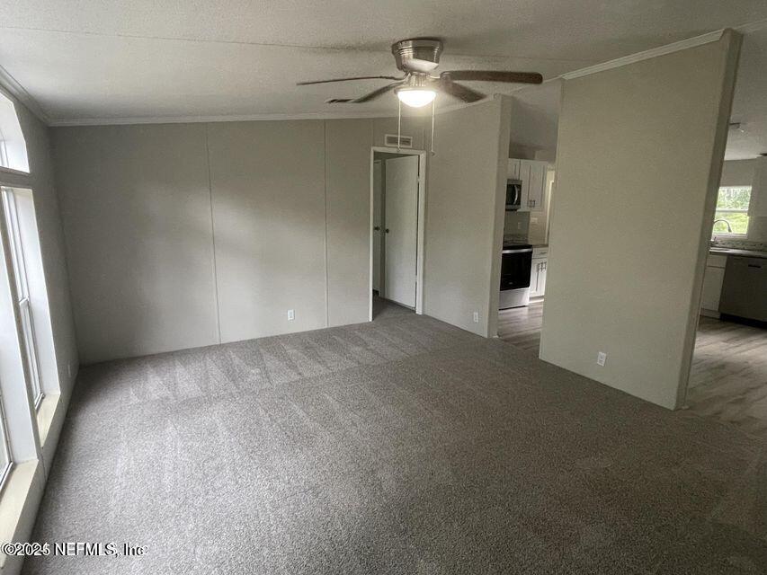 67089 Elnora Lane Yulee, FL 32097 - Photo 14 of 19 en empty room with windows and entrance