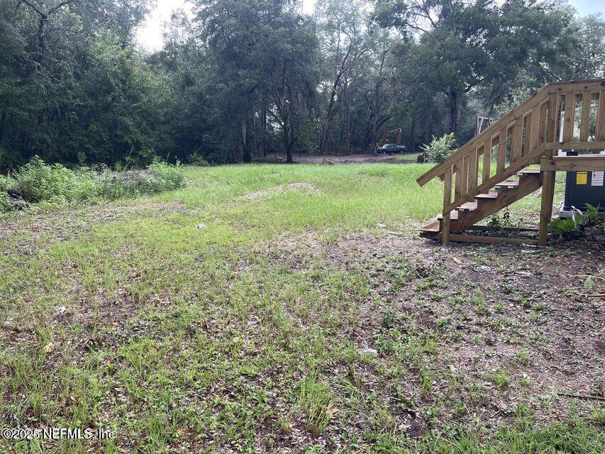 67089 Elnora Lane Yulee, FL 32097 - Photo 19 of 19 a view of a house with a yard