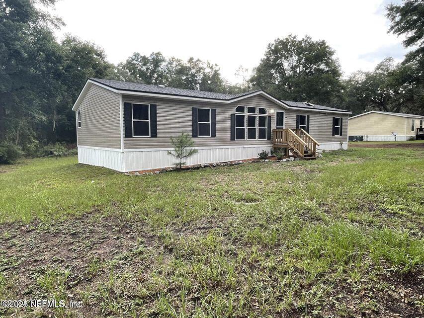 67089 Elnora Lane Yulee, FL 32097 - Photo 3 of 19 a view of a house with a yard