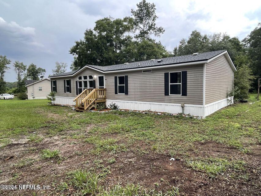 67089 Elnora Lane Yulee, FL 32097 - Photo 4 of 19 a view of a house with a yard