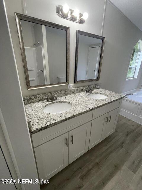 67089 Elnora Lane Yulee, FL 32097 - Photo 10 of 19 a bathroom with a granite countertop sink and a mirror