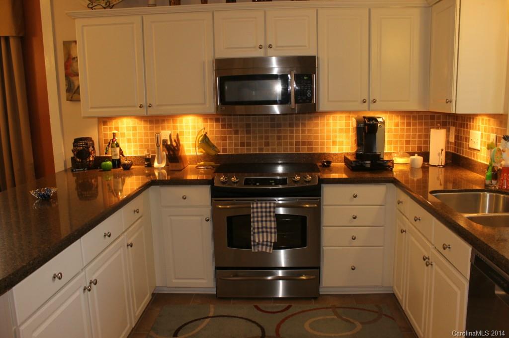 8135 Townley Road Huntersville, NC 28078 - Photo 4 of 21 a kitchen with granite countertop a stove and a sink