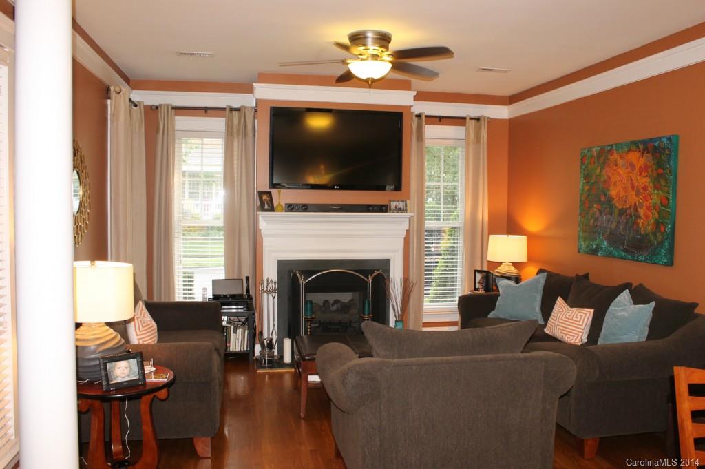 8135 Townley Road Huntersville, NC 28078 - Photo 5 of 21 a living room with furniture a flat screen tv and a fireplace