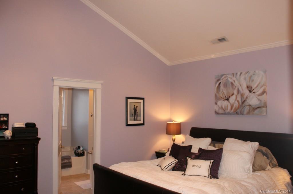 8135 Townley Road Huntersville, NC 28078 - Photo 8 of 21 a bed room with a bed and a painting on the wall