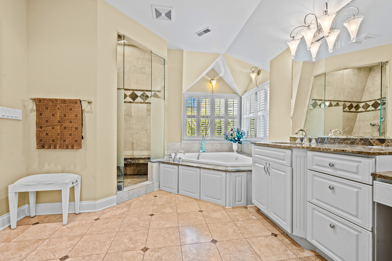 780 Prairie Road Glencoe, IL 60022 - Photo 16 of 30 a spacious bathroom with a granite countertop sink a mirror and a bathtub