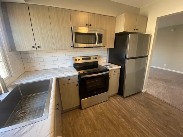 a kitchen with a refrigerator sink and microwave