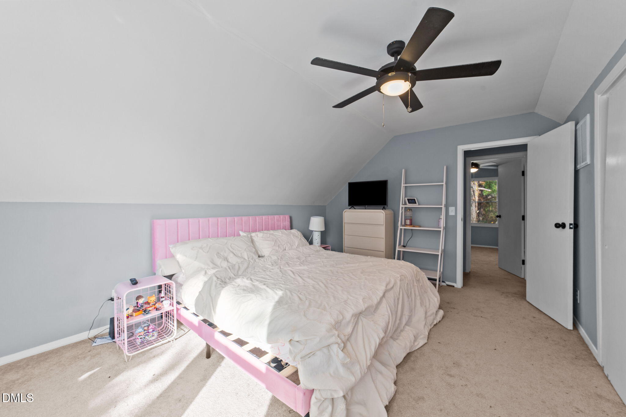 2874 Beulahtown Road Kenly, NC 27542 - Photo 20 of 40 a bedroom with a bed and a chandelier