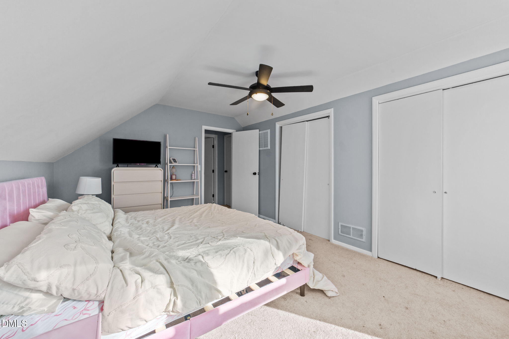 2874 Beulahtown Road Kenly, NC 27542 - Photo 21 of 40 a bedroom with a bed and a chandelier