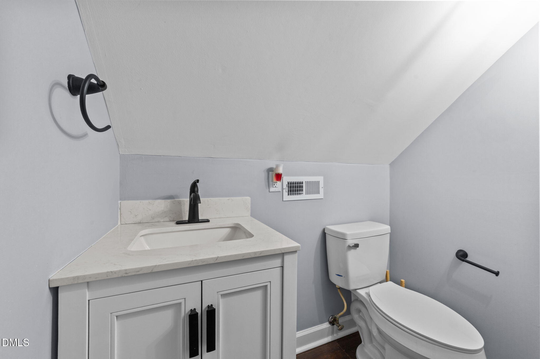 2874 Beulahtown Road Kenly, NC 27542 - Photo 24 of 40 a bathroom with a toilet sink vanity and mirror