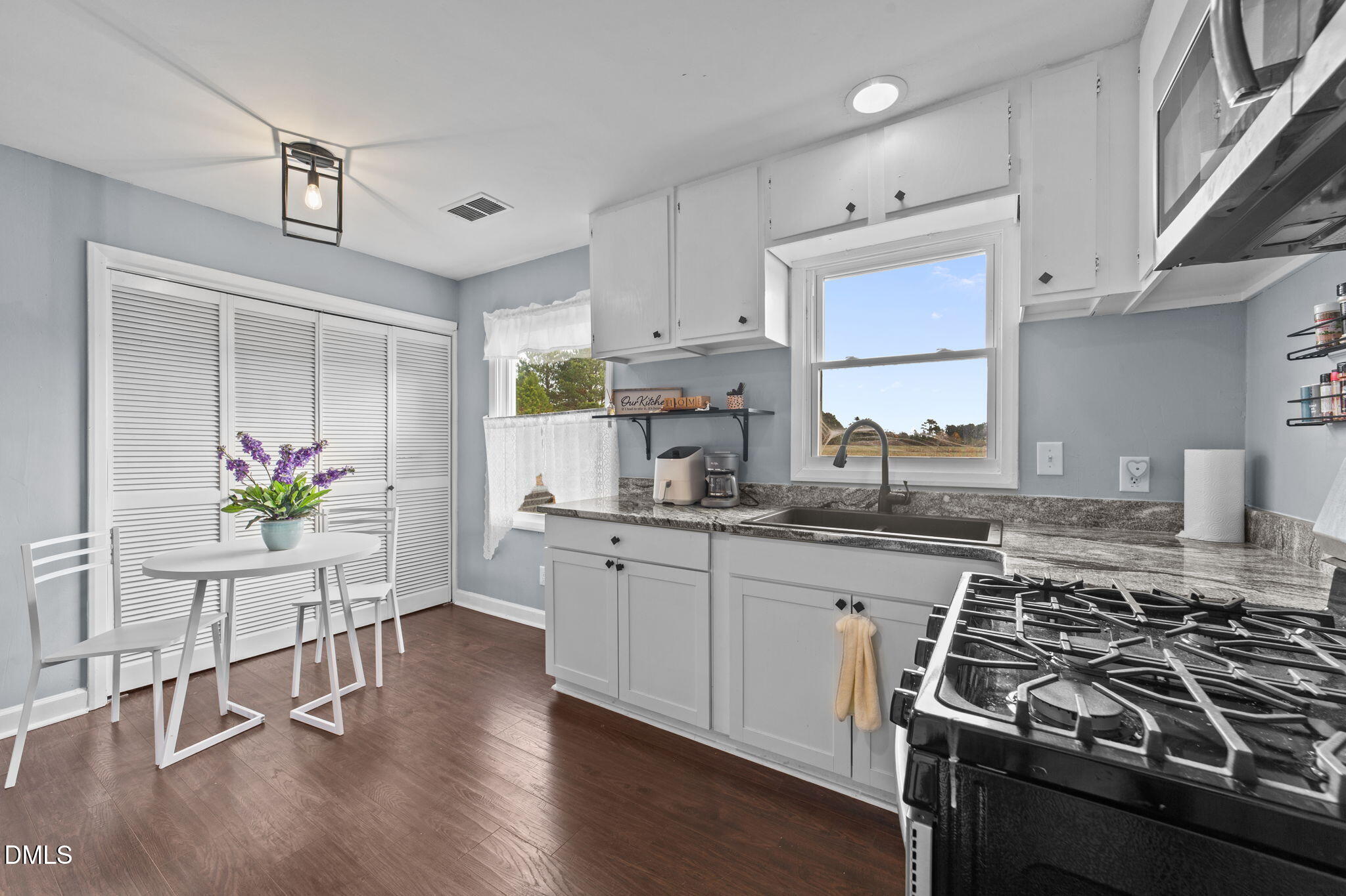 2874 Beulahtown Road Kenly, NC 27542 - Photo 8 of 40 a kitchen with stainless steel appliances a stove a sink cabinets and wooden floor