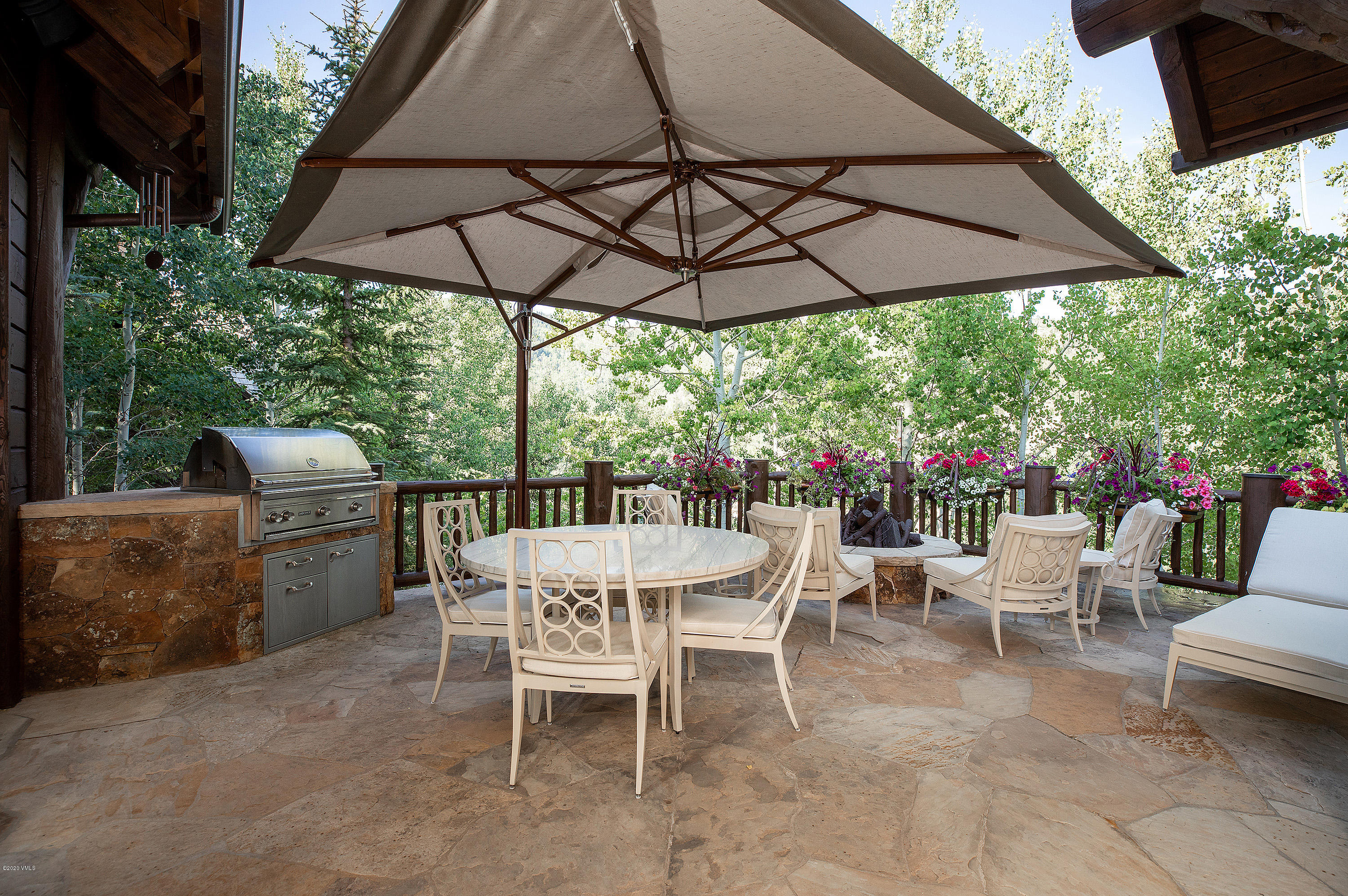 2178 Cresta Road Edwards, CO 81632 - Photo 13 of 15 a view of a chairs and table under an umbrella in the patio