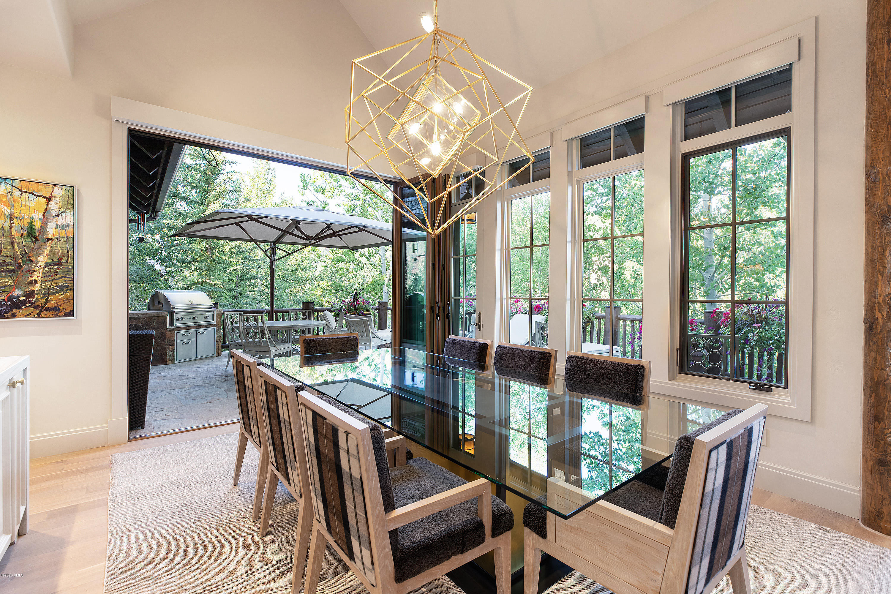 2178 Cresta Road Edwards, CO 81632 - Photo 4 of 15 a dining room with furniture a chandelier and wooden floor