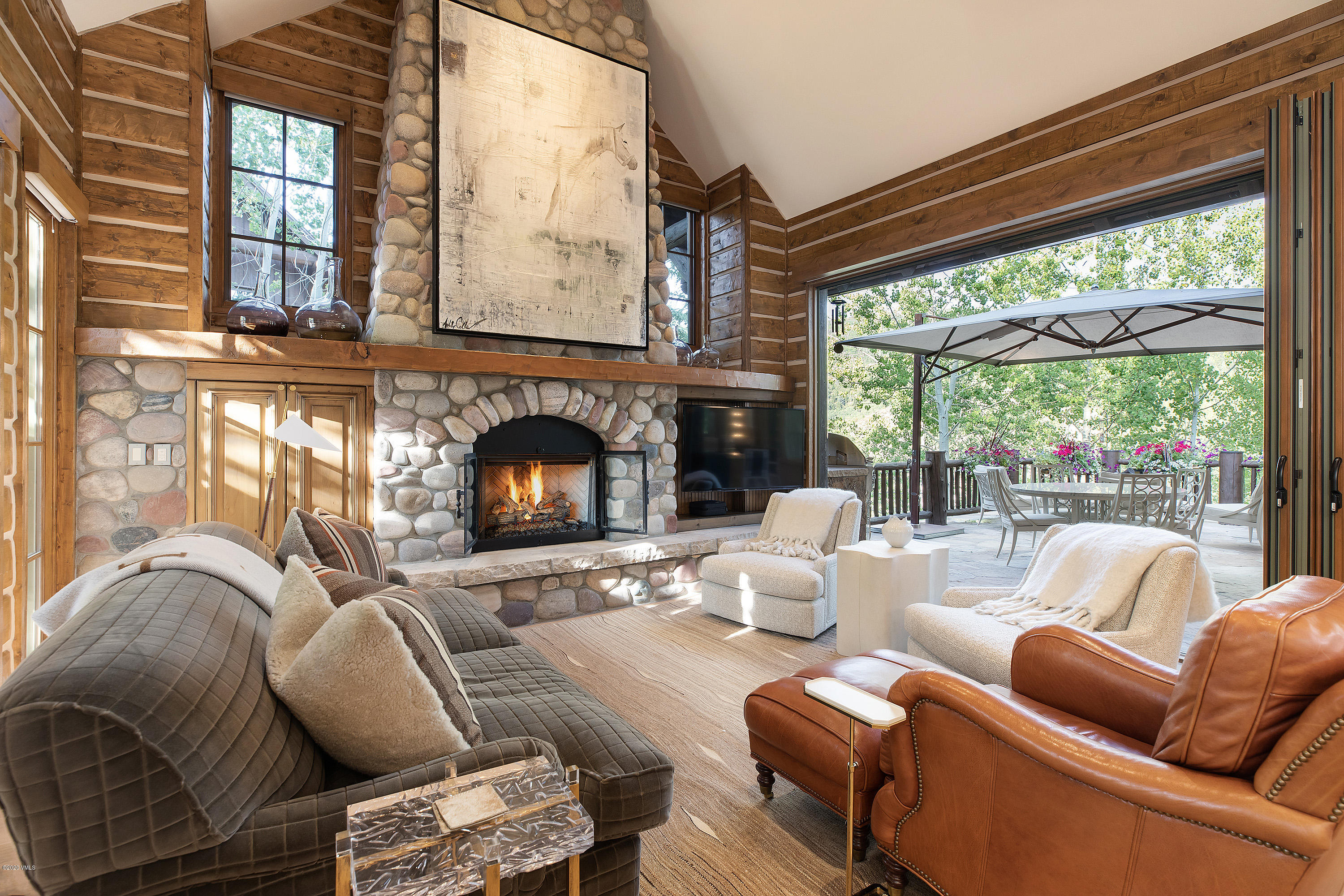 2178 Cresta Road Edwards, CO 81632 - Photo 7 of 15 a living room with furniture a fireplace and floor to ceiling windows