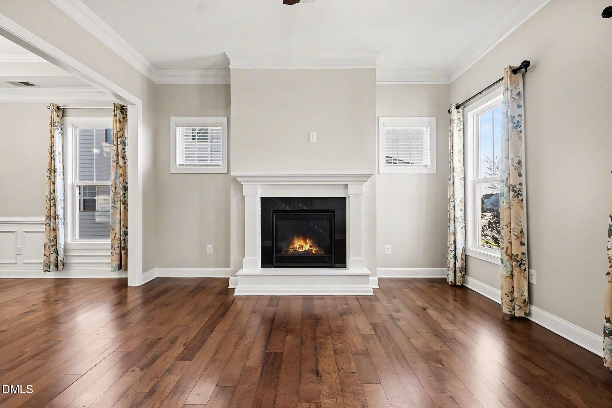 1213 Hemby Ridge Lane Morrisville, NC 27560 - Photo 17 of 60 a view of a livingroom with wooden floor and a fireplace