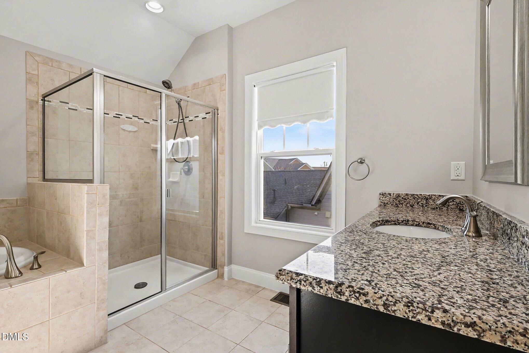 1213 Hemby Ridge Lane Morrisville, NC 27560 - Photo 42 of 60 a bathroom with a granite countertop sink a mirror and shower