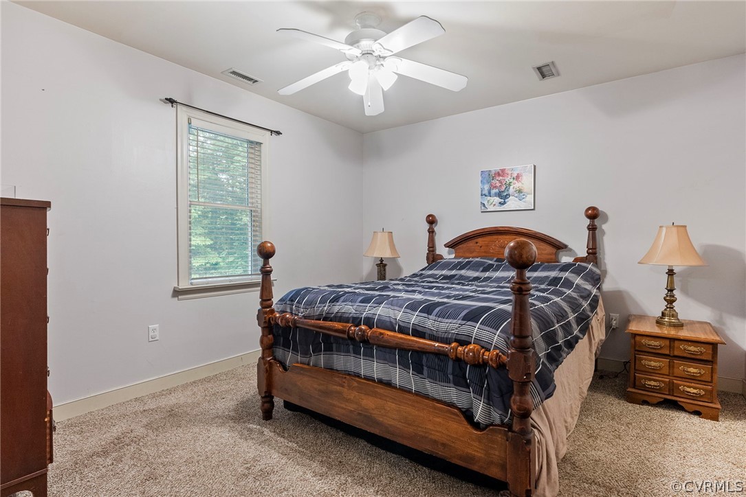 1775 Hawk Town Road Maidens, VA 23102 - Photo 7 of 27 a bedroom with a bed and a chandelier