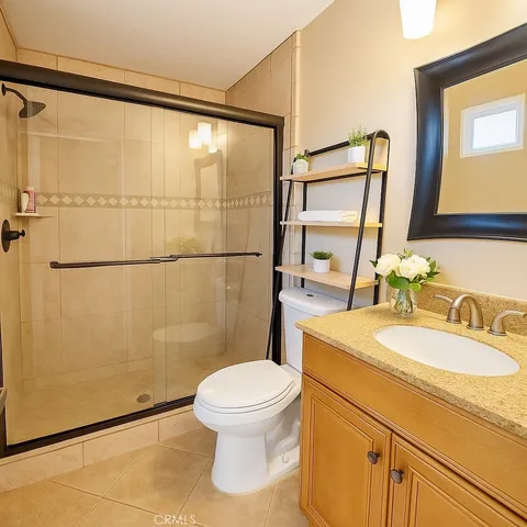 a white toilet sitting next to a bathroom sink