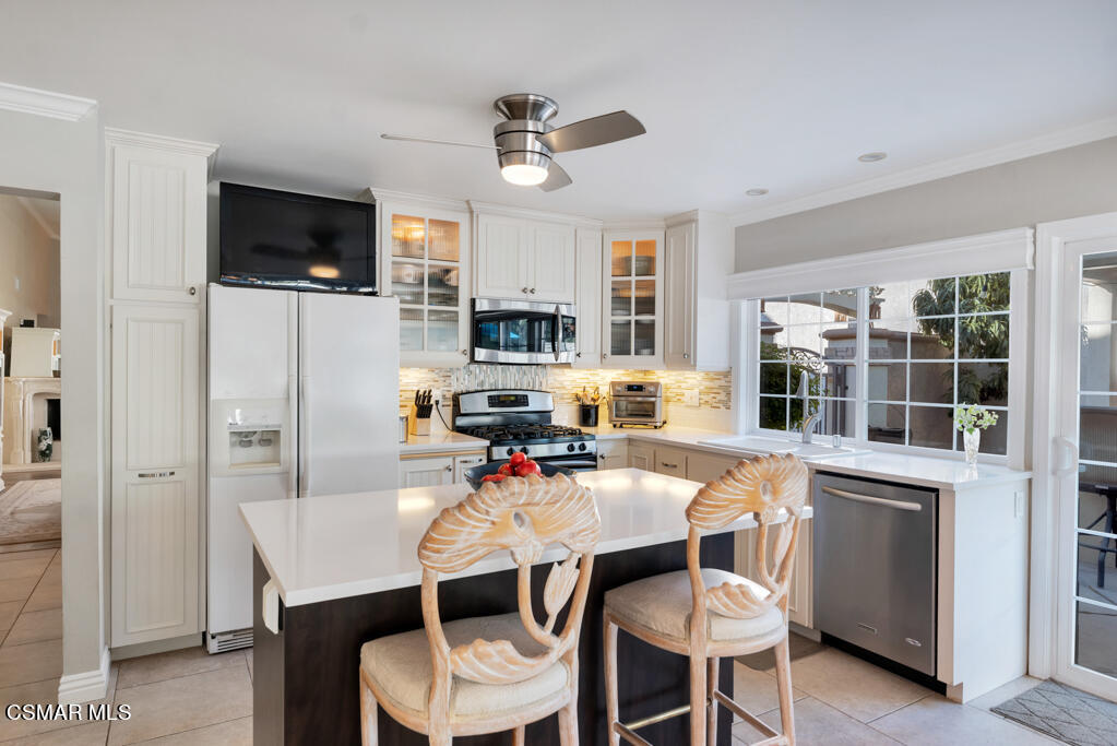 2932 Morningside Drive Thousand Oaks, CA 91362 - Photo 13 of 39 a view of a dining room with furniture a kitchen wooden floor and a window