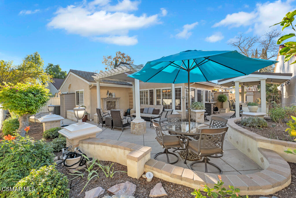 2932 Morningside Drive Thousand Oaks, CA 91362 - Photo 37 of 39 a view of a patio with chairs and table under an umbrella