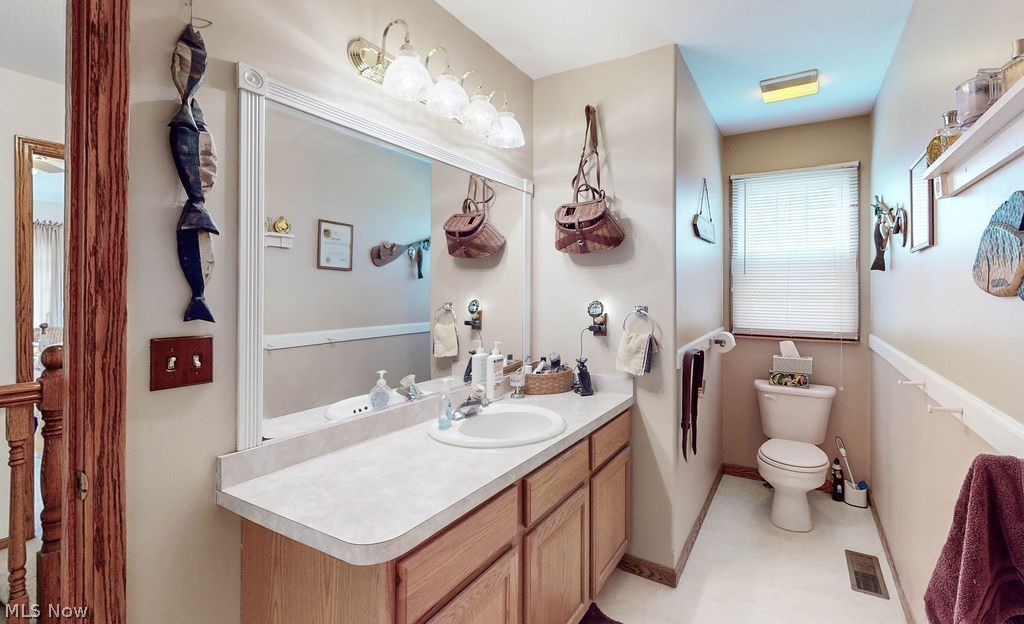 10147 Page Road Streetsboro, OH 44241 - Photo 25 of 35 Bathroom featuring toilet, tile floors, and vanity with extensive cabinet space