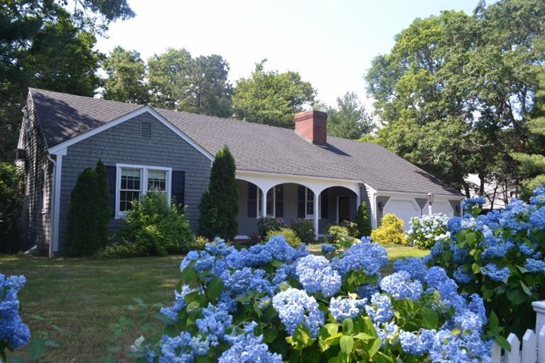 72 Rolling Hitch Road Centerville, MA 02632 - Photo 3 of 28 a front view of house and yard with lots of flower and trees