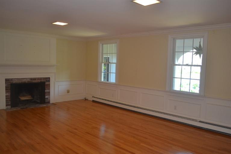 72 Rolling Hitch Road Centerville, MA 02632 - Photo 9 of 28 wooden floor fireplace and windows in an empty room