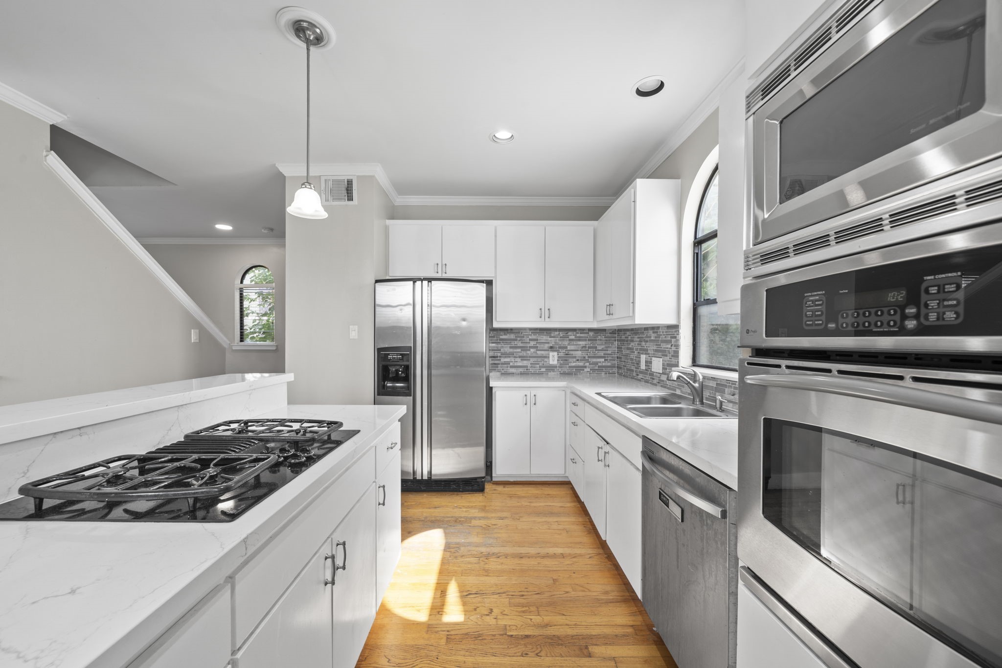 2154 Arabelle Street Houston, TX 77007 - Photo 24 of 45 The quartz countertops and clean finishes give the kitchen a sharp, updated presence. Every detail feels simple, functional, and ready for everyday living.