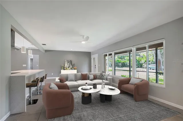 a large kitchen with a large counter top a sink stainless steel appliances and cabinets