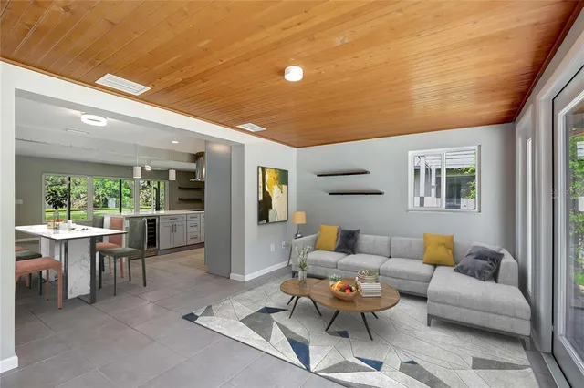 a view of a big room with windows and chandelier fan