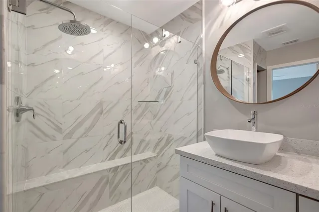 a bathroom with a sink toilet and mirror