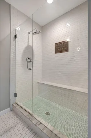 a view of a swimming pool with an outdoor seating area and trees around