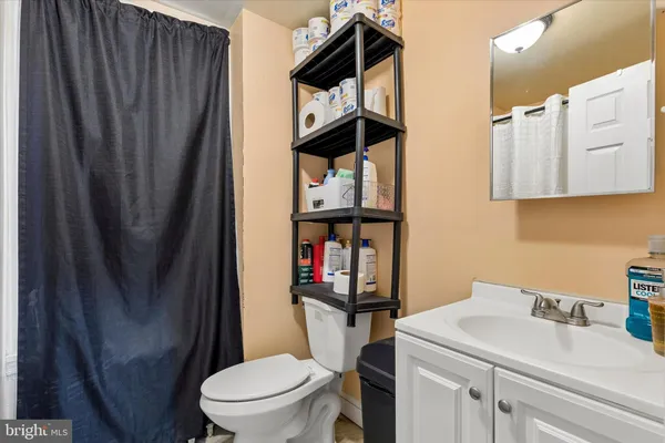 a bathroom with a toilet and a shower curtain
