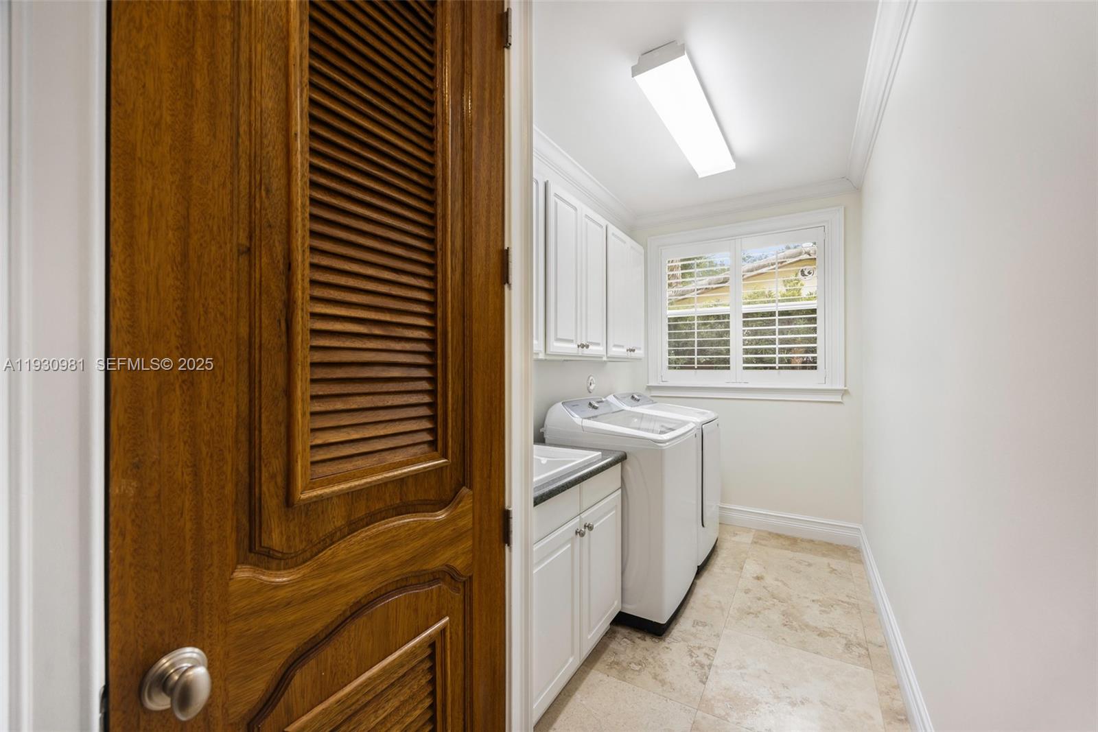 4065 Battersea Road Coconut Grove, FL 33133 - Photo 30 of 40 Laundry room with built-in cabinetry and connecting to double car garage
