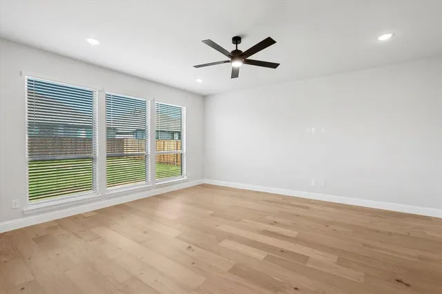 a view of a livingroom with a ceiling fan and window