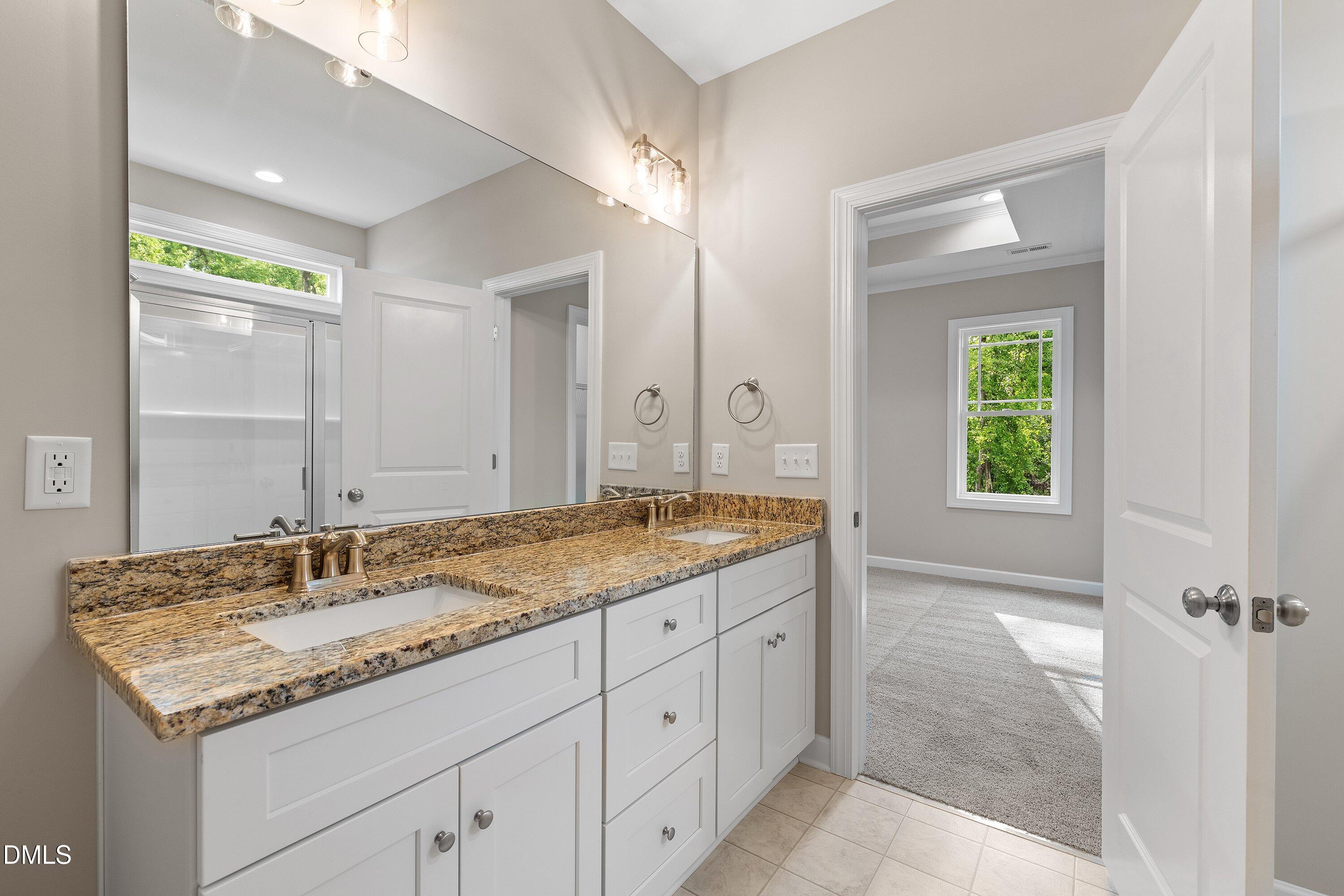 1115 Nor-Am Road Pikeville, NC 27863 - Photo 31 of 40 a bathroom with a granite countertop sink and a mirror