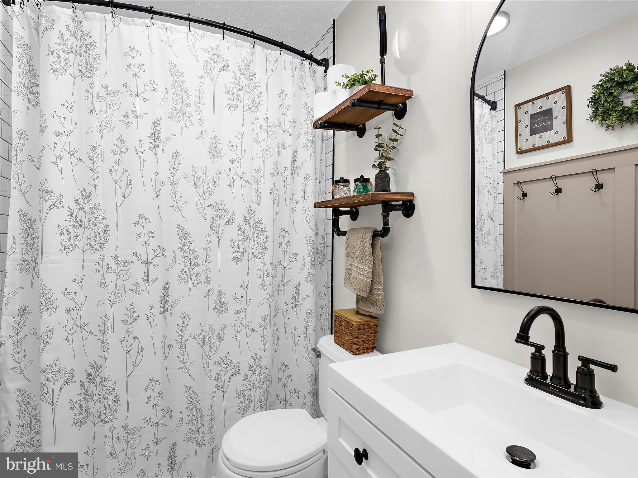 243 Seneca Terrace Pasadena, MD 21122 - Photo 17 of 35 a bathroom with a sink and toilet