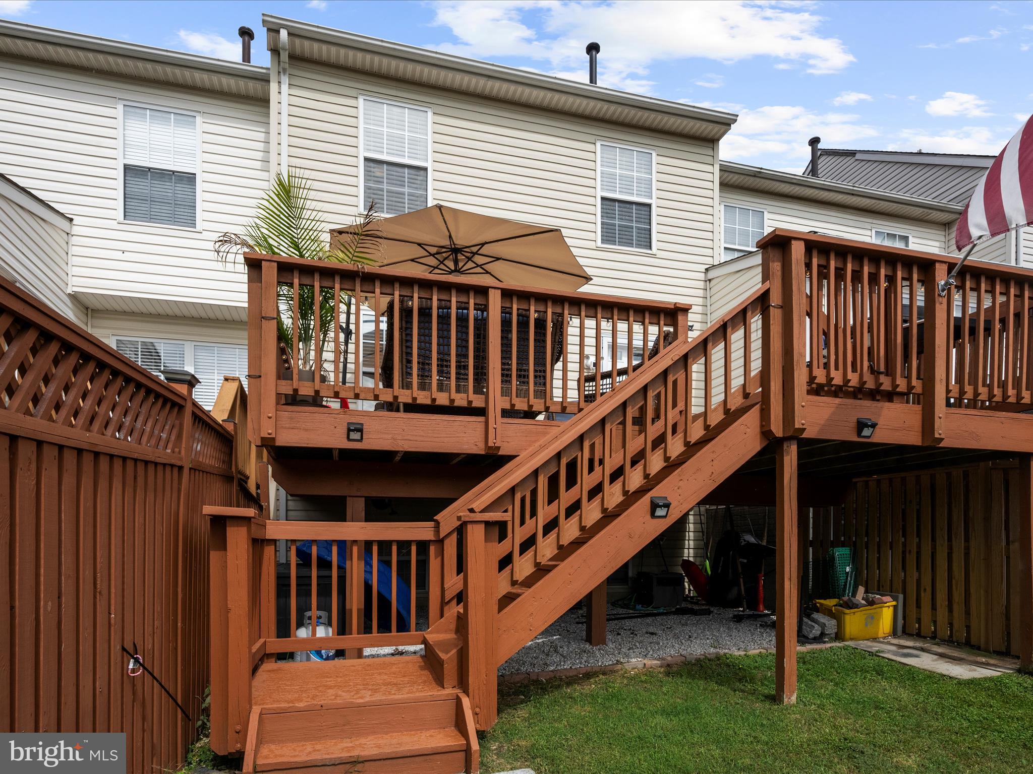 243 Seneca Terrace Pasadena, MD 21122 - Photo 26 of 35 a view of a house with wooden deck stairs and a wooden fence