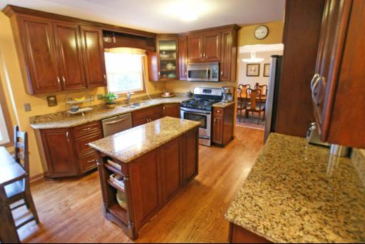 151 South Raddant Road Batavia, IL 60510 - Photo 4 of 16 a kitchen with wooden cabinets and a stove