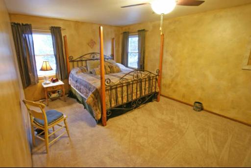 151 South Raddant Road Batavia, IL 60510 - Photo 8 of 16 a bedroom with a bed and wooden floor